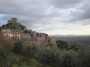 Montemassi, Roccastrada (GR) - Il borgo visto da via Matteotti con le case sovrastate dal castello medievale e circondato da ulivi - Fotografia 8 dicembre 2011, Toscana