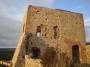 Montemassi, Roccastrada (GR) - Il prospetto della antica rocca del castello realizzata in pietra. La rocca ha un basamento a scarpa e mostra porte e finestre ad arco - Fotografia 8 dicembre 2011, Toscana