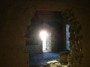 Montemassi, Roccastrada (GR) - La luce del sole al tramonto filtra da una finestra ad arco della antica torre in pietra del castello - Fotografia 8 dicembre 2011, Toscana
