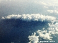 Isola del Giglio (GR) - Foto aerea. Uno scatto della splendida Isola del Giglio coperta da una fitta nuvola. La foto è scattata da circa 32000 piedi di altitudine ovvero da una quota di quasi 10000 metri dal livello del mare. (Ottobre 2006)